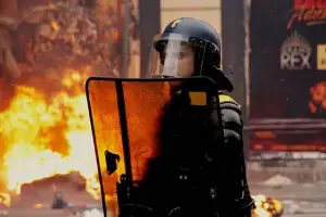 a police men protects during riots